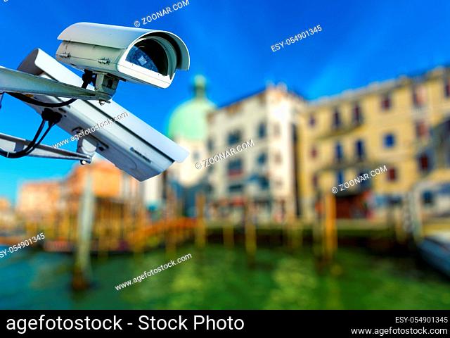 security CCTV camera with canal grande of venice on blurry background