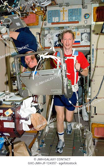 European Space Agency astronaut Frank De Winne, Expedition 20 flight engineer, equipped with a bungee harness, exercises on the Treadmill Vibration Isolation...