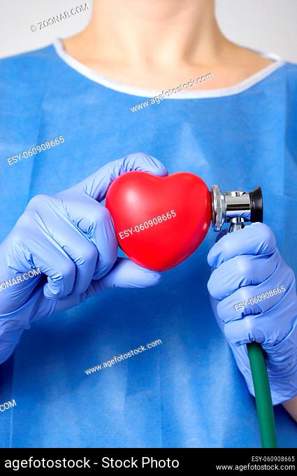 Red heart and stethoscope in the hand of a doctor