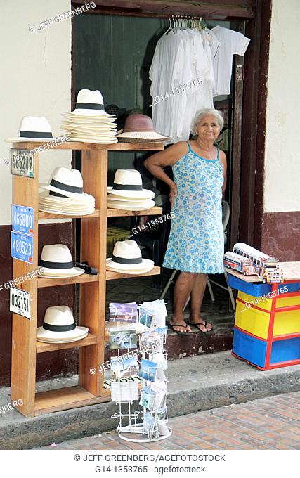 Panama, Panama City, Casco Viejo, San Felipe, souvenirs, sidewalk display, store, business, merchant, Hispanic, woman, Pahana hat, post card