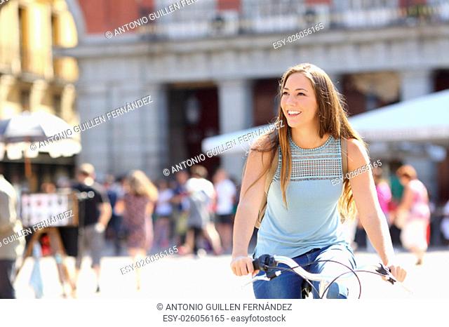 Candid tourist cyclist sightseeing in a old town of a city