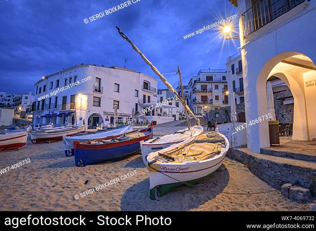 Blue hour and sunrise in the fishing village of Calella de Palafrugell, with its boats and white houses, on the Costa Brava coast (Empordá , Girona, Catalonia