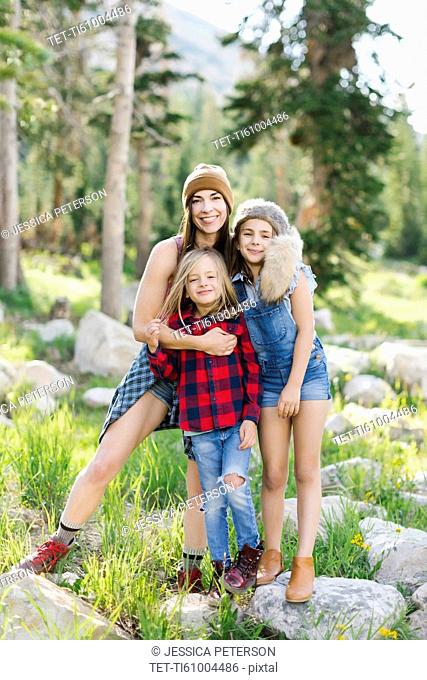Portrait of mother with son (6-7) and daughter (8-9) hiking in forest