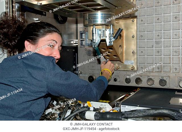 NASA astronaut Nicole Stott, Expedition 21 flight engineer, installs the Light Microscopy Module (LMM) Spindle Bracket Assembly in the Fluids Integrated Rack...