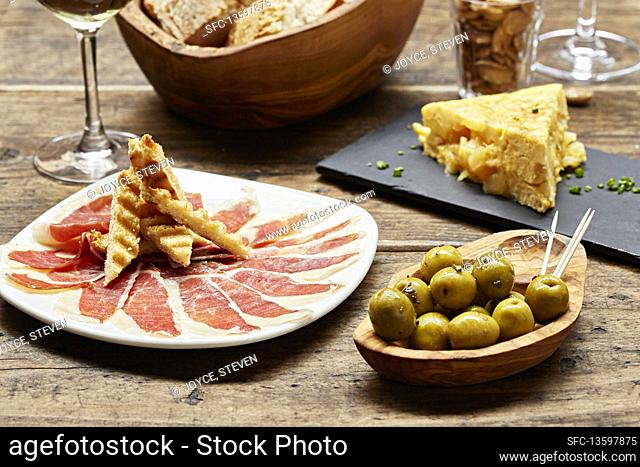 Spanish tapas Parma ham, olives and a tortilla