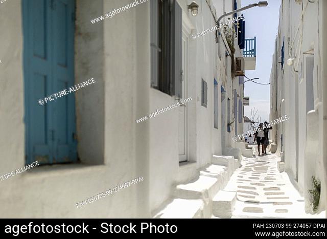 15 June 2023, Greece, Mykonos: Tourists walk in a small alley in the center of Mykonos. Photo: Socrates Baltagiannis/dpa. - Mykonos/Greece