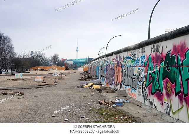 Construction materials and rubbish lies in front of the wall of the East Side Gallery in Berlin, 9 March 2013. The East Side Gallery is the longest stretch of...