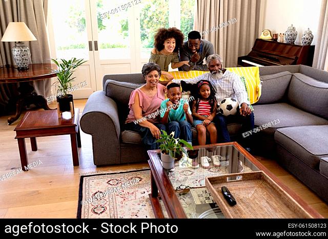 Mixed race family spending time together sitting on a couch