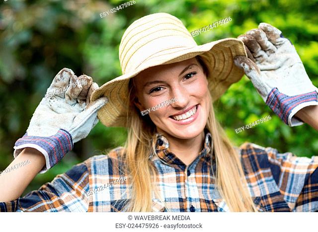 Happy female gardener wearing hat