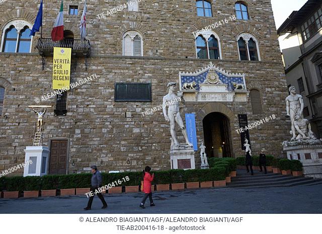 Banner 'Truth for Giulio Regeni' exposed on Palazzo Vecchio, under the banner the sculpture by Jan Fabre 'Man who measures the clouds', Florence