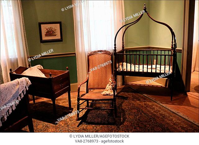 This 1800's wood crib waits patiently for a sleepy little head in the nursery of the big house at Laura Plantation, Vacherie, Louisiana, USA