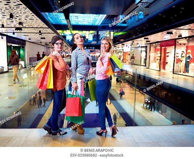 happy young girls in shopping mall, friends having fun together