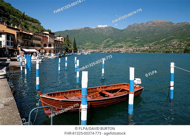 Boats in harbour of town on lake island, Peschiera Maraglio, Monte Isola, Lago d'Iseo, Lombardy, Italy, May