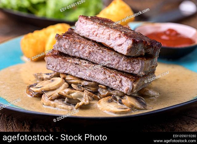 slices of a steak with mushroom sauce