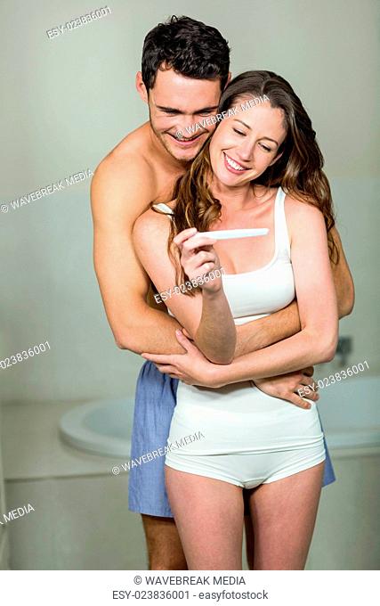 Happy couple embracing in bathroom