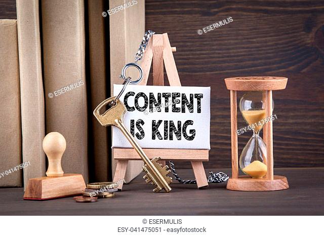 content is king concept. Sandglass, hourglass or egg timer on wooden table showing the last second or last minute or time out