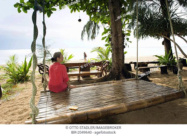 Woman sitting at the CoCo beach bar, Ko Jum or Koh Pu island, Krabi, Thailand, Southeast Asia