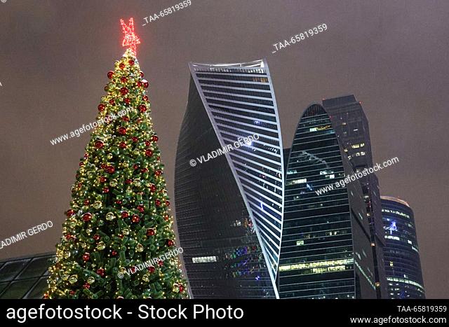 RUSSIA, MOSCOW - DECEMBER 16, 2023: A decorated Christmas tree is seen near towers of the Moscow International Business Centre. Vladimir Gerdo/TASS