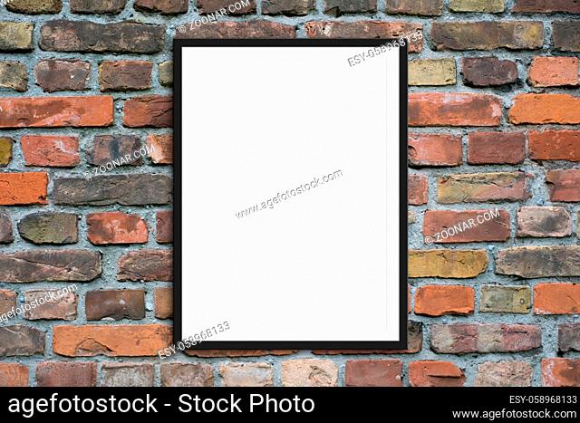 blank picture frame hanging on brick wall - framed poster mock-up with stone wall background