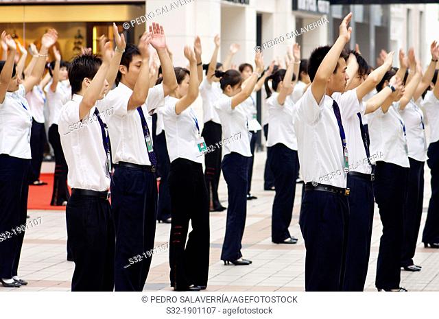 A department store workers perform exercises before starting their workday  Beijing, China