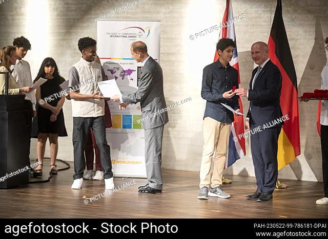 22 May 2023, Berlin: Prince Edward (M), Duke of Edinburgh, presents successful participants in the Duke of Edinburgh's International Award program with their...