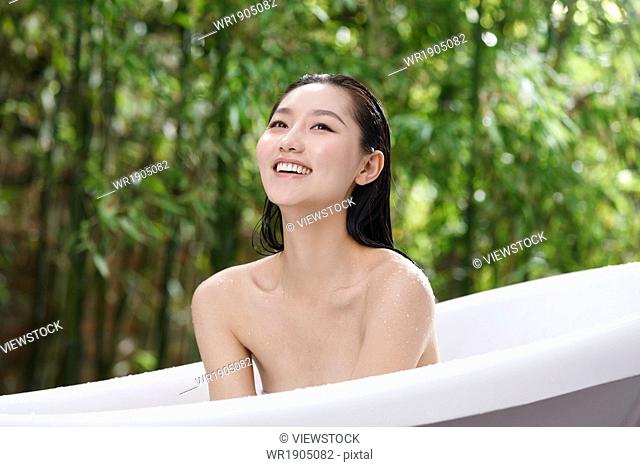 The young woman in the outdoor bathing
