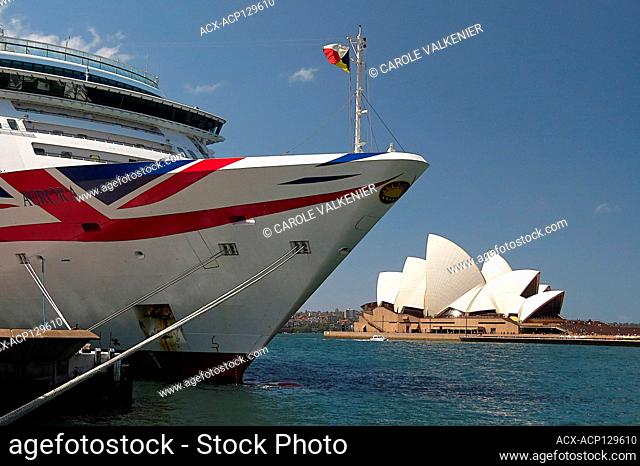 Ship moored at dock with opera house in the background, Sydney, Australia