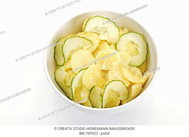 Bowl of cucumber and potato salad with oil and vinegar dressing