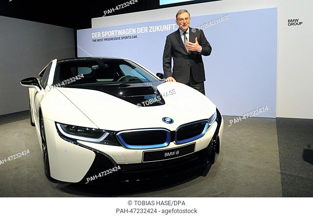 Chairman of the board of BMW, Norbert Reithofer, stands next to a BMW i8 during the company's annual results press conference in Munich, Germany, 19 March 2014