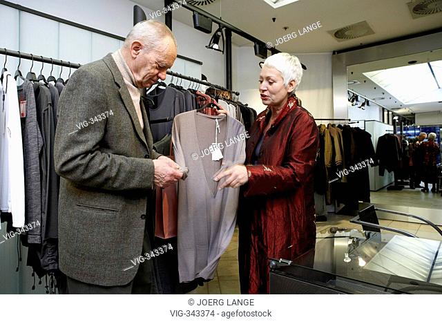 An ellderly couple is shopping in a fashion boutique. - Berlin, GERMANY, 02/12/2006