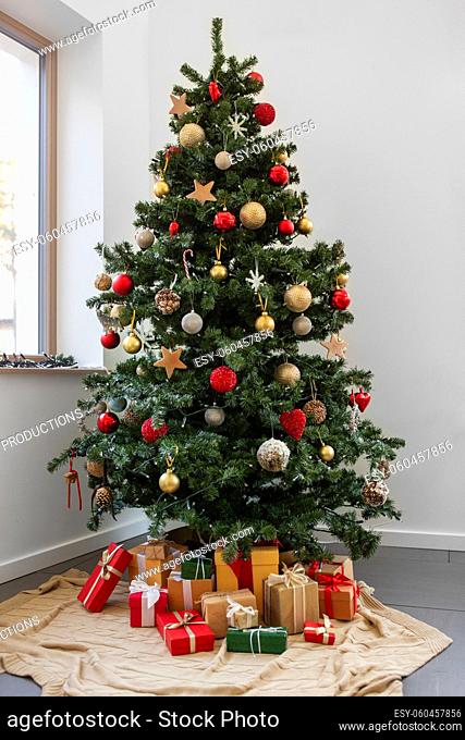 gifts under decorated christmas tree at home