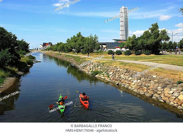 Sweden, Skane County, Malmo, sea kayaking along city canals and the Turning Torso tower by architect Santiago Calatrava in the background