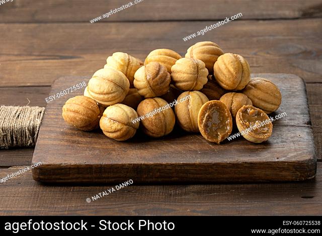 baked dessert nuts with condensed milk on a wooden board, top view