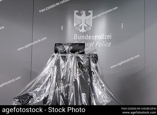 05 May 2022, Hessen, Frankfurt/Main: Still wrapped in foil is the chair at the passport control point of the Federal Police at Pier G of Terminal 3 at Frankfurt...