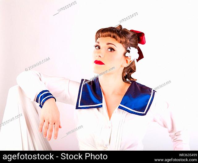 young girl in fifties pin-up style wearing a sailors uniform