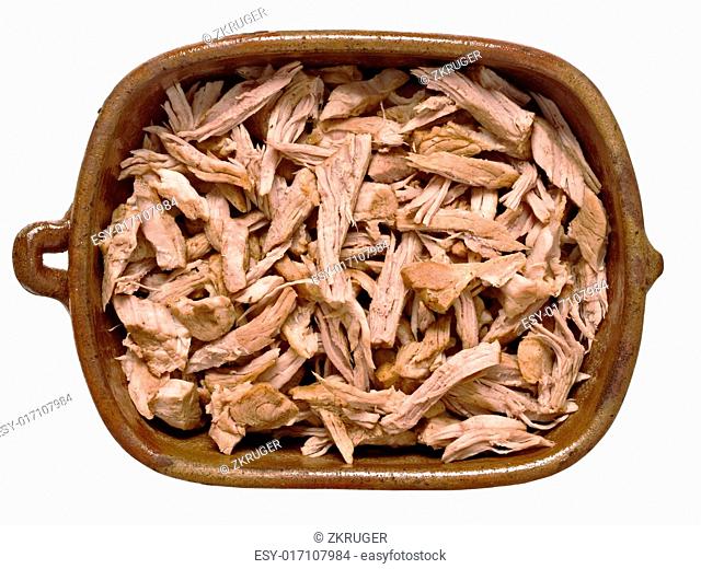 close up of a bowl of rustic pulled pork isolated