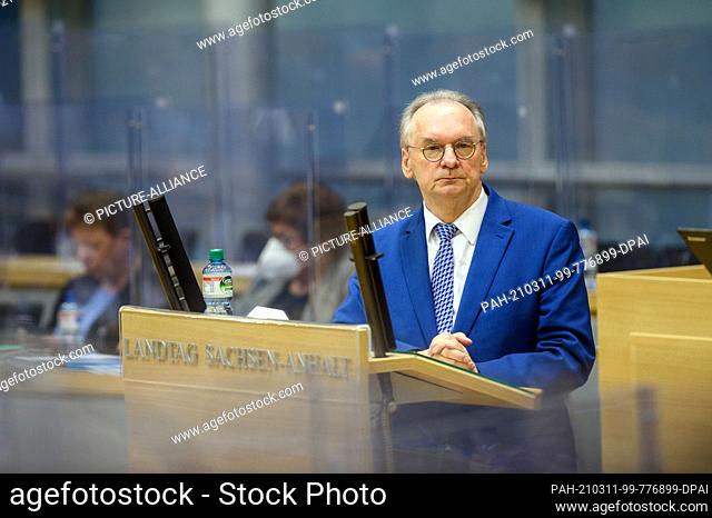 04 March 2021, Saxony-Anhalt, Magdeburg: Reiner Haseloff (CDU), Minister President of Saxony-Anhalt, stands at the lectern in the plenary hall of the state...