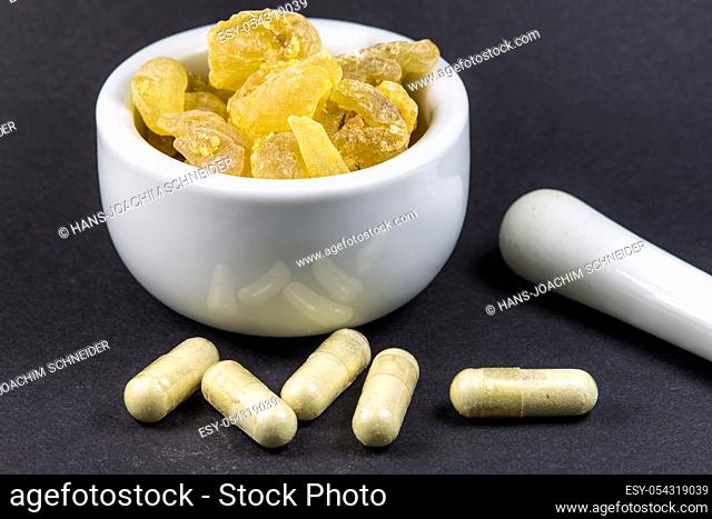 Olibanum, pieces in a mortar with olibanum capsules