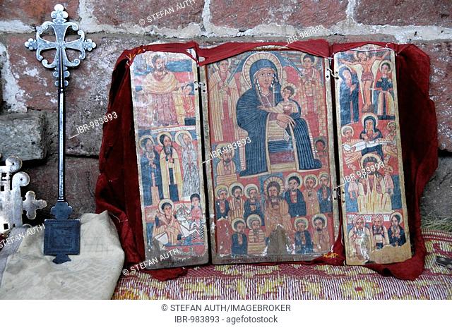 Ethiopian Orthodox Christianity, opened triptych of Madonna and Child surrounded by the saints and an iron cross, church treasures in a rock hewn church