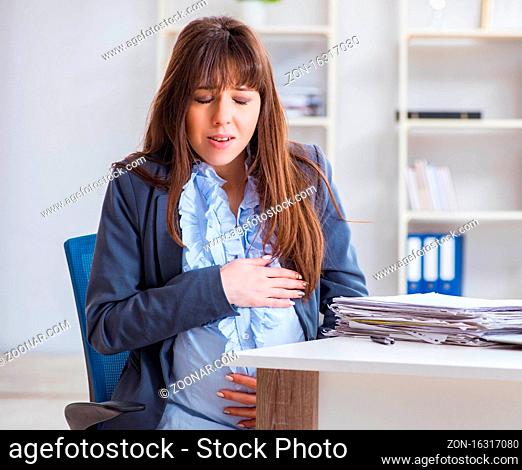 The pregnant woman struggling to do work in office