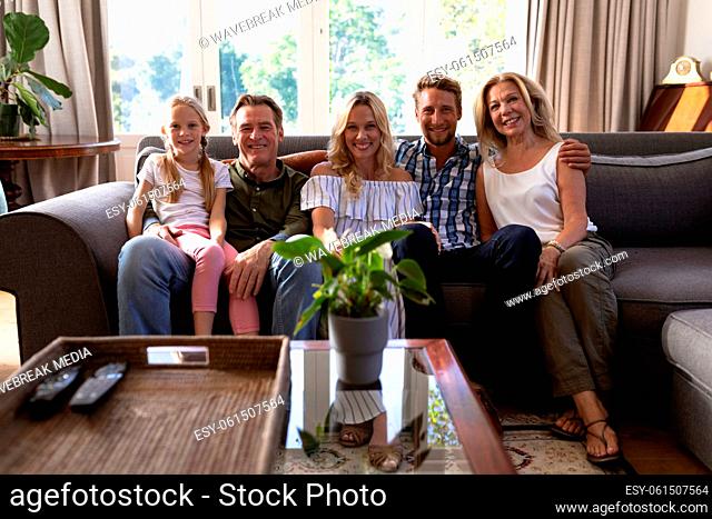 Multi-generation Caucasian family sitting on a couch together