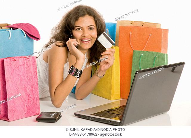 Girl on laptop doing online shopping Pune Maharashtra India Asia MR686 M June 2011