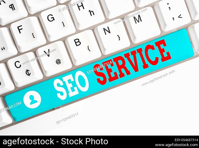Word writing text Seo Service. Business photo showcasing techniques and procedures to increase the website visibility White pc keyboard with empty note paper...