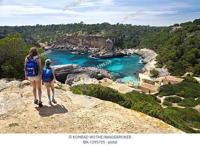 Mother and daughter walking to the bay Cala s'Almonia, Mallorca, Majorca, Balearic Islands, Mediterranean Sea, Spain, Europe