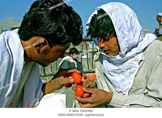 Afghan adults are playing with eggs called Egg fighting or Tokham Jangi at the Kabul bazaar Afghanistan October 11, 2007