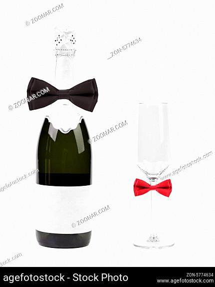Champagne bottle and glass decorated with bows. White background