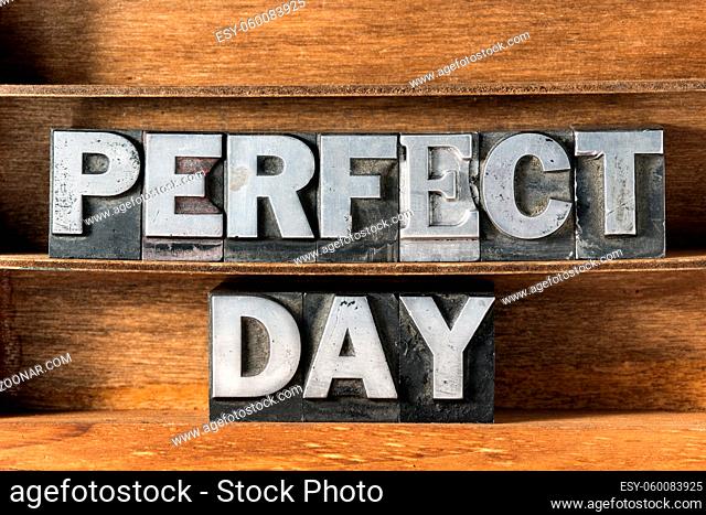 perfect day phrase made from metallic letterpress type on wooden tray