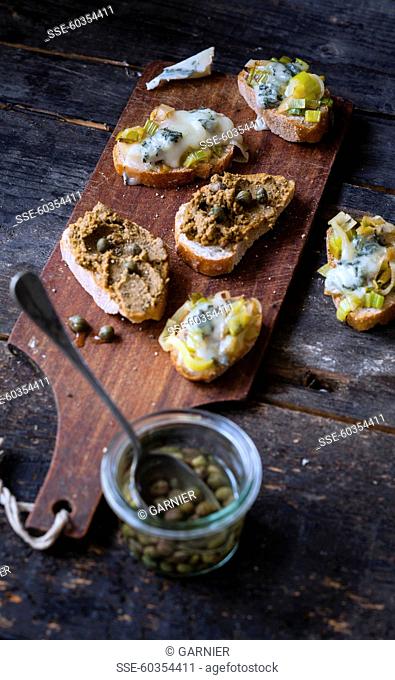 Caper tapenade crostinis and grilled leek fondue and gorgonzola crostinis