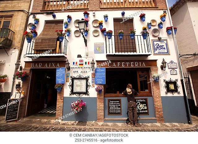 Flower pots hanging on the facade of a restaurant in Albayzin neighborhood, Albaycin, Albaicin, UNESCO World Heritage Site, Granada, Andalusia, Spain, Europe