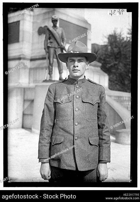 Young man in uniform standing in front of Sherman Monument, Washington, D.C., between 1916 and 1918. Creator: Harris & Ewing